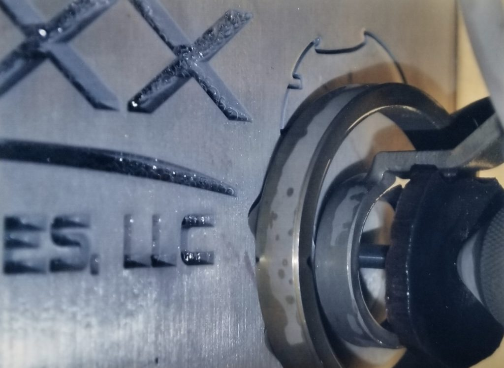 Close-up of high-pressure waterjet cutting head in operation